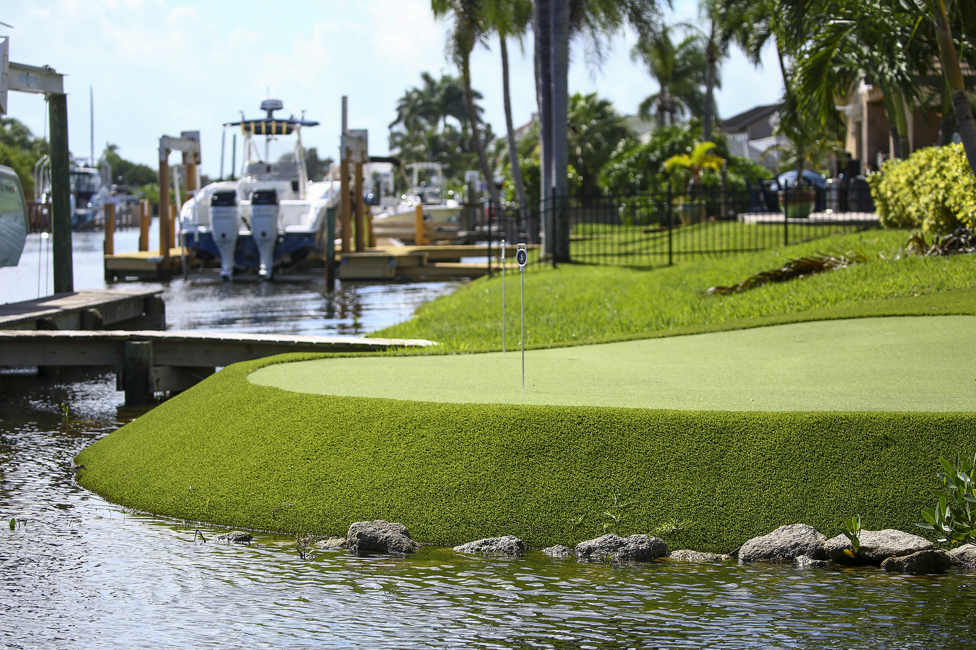 Houses dot canals around the Indian River Lagoon, including one home
                that has a putting green in the yard.