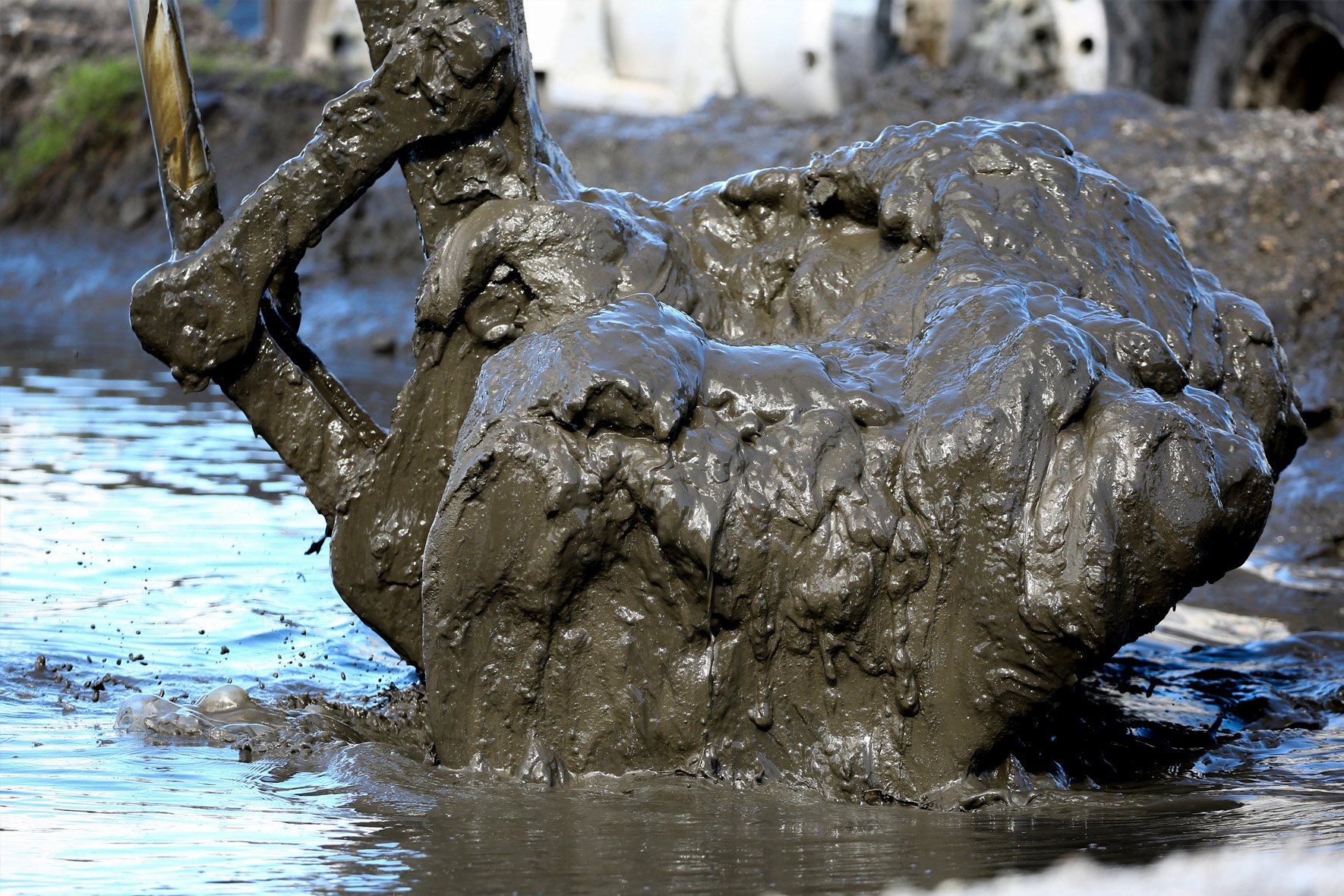 An excavator lifts muck as part of an expensive effort to clean the Lagoon.